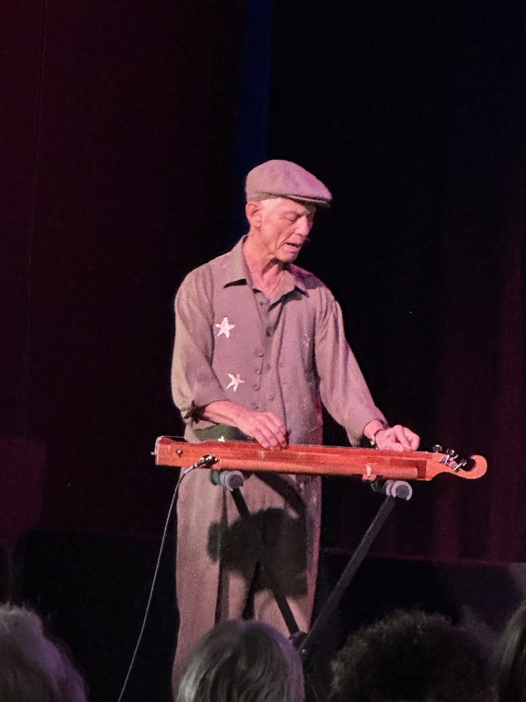 Rudi Harst playing keyboard onstage