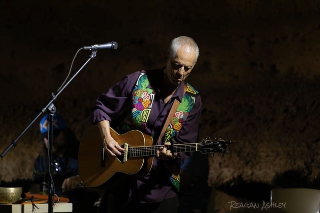 Rudi Harst performing in an intimate cave venue