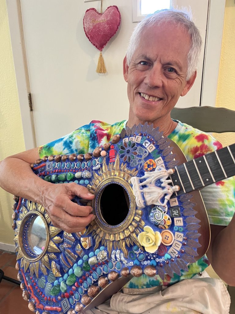Rudi Harst holding a colorful ceremonial object