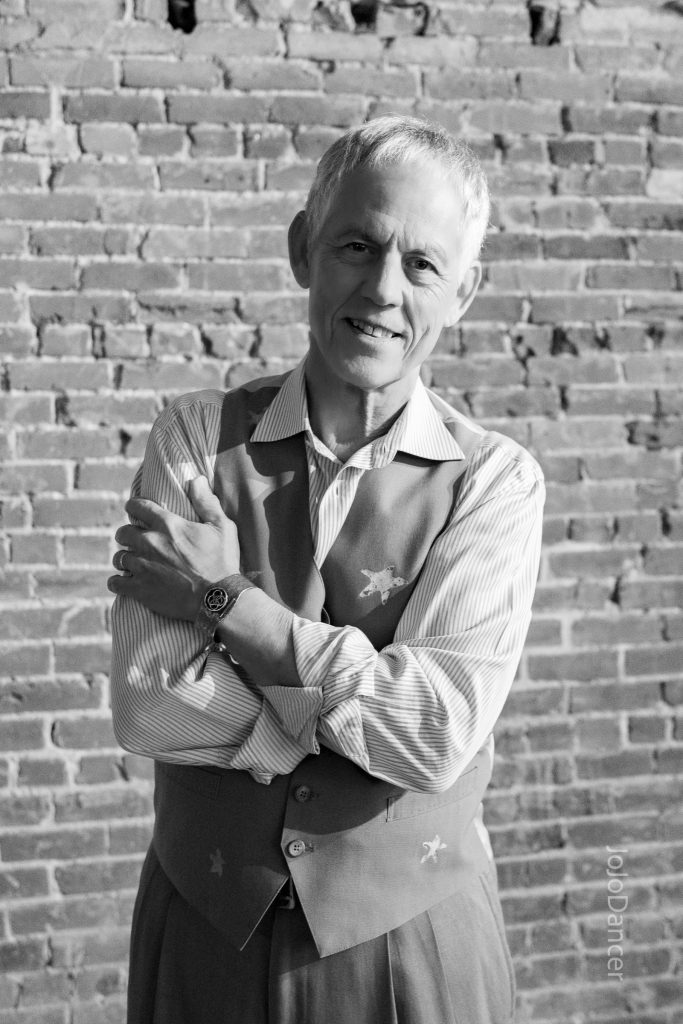 Rudi Harst posed against a brick wall