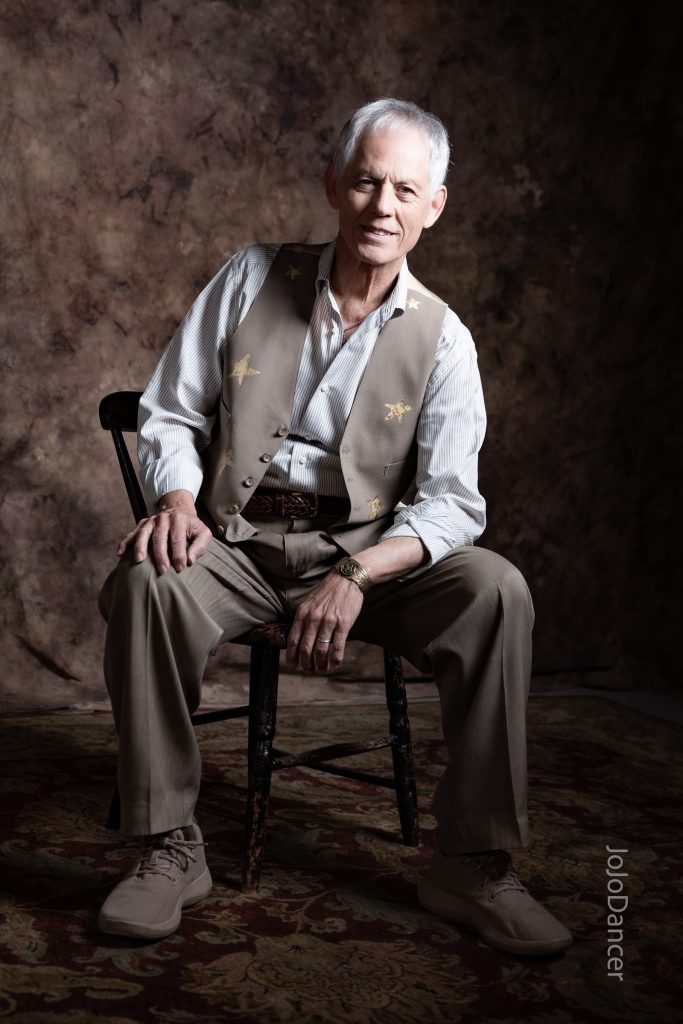 Rudi Harst seated in a reflective portrait