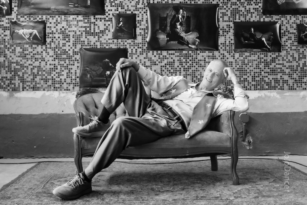 Rudi Harst reclining in a black-and-white portrait
