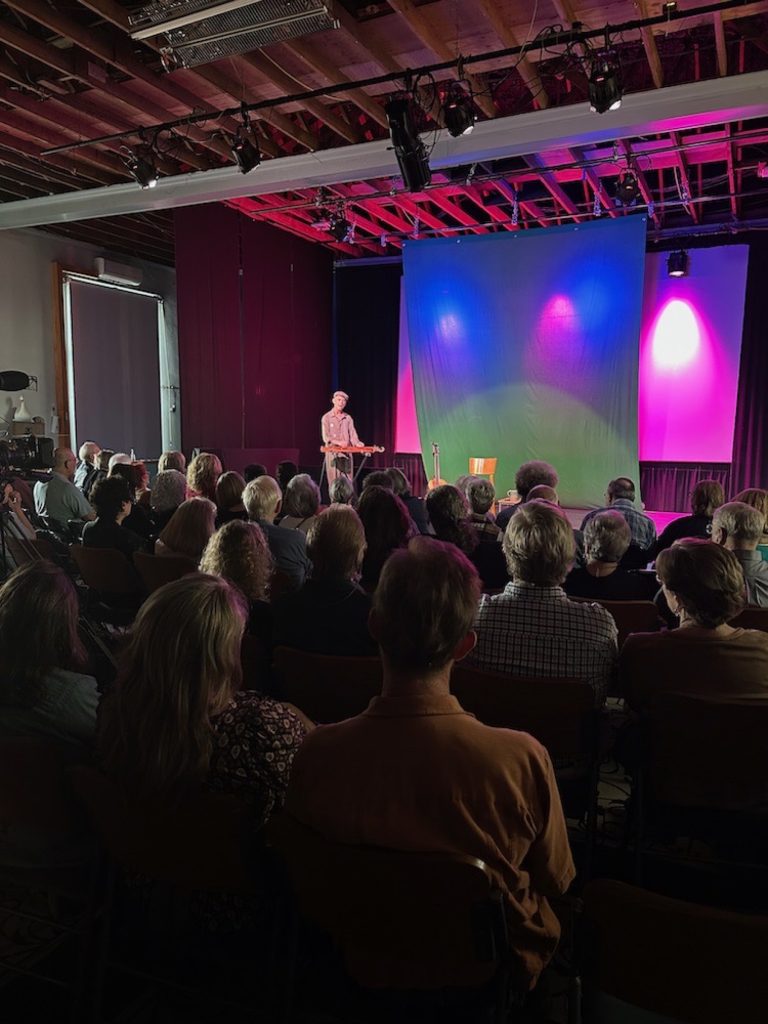 Audience gathered for a Rudi Harst performance