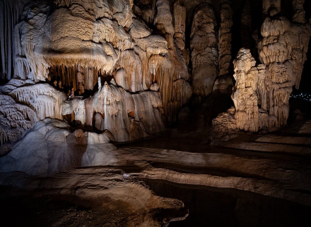 Layered cave formations illuminated against the dark interior